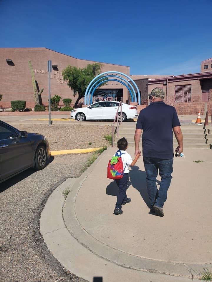 man walking his child to daycare at tuscon